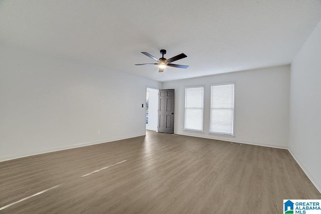 spare room with ceiling fan and hardwood / wood-style floors