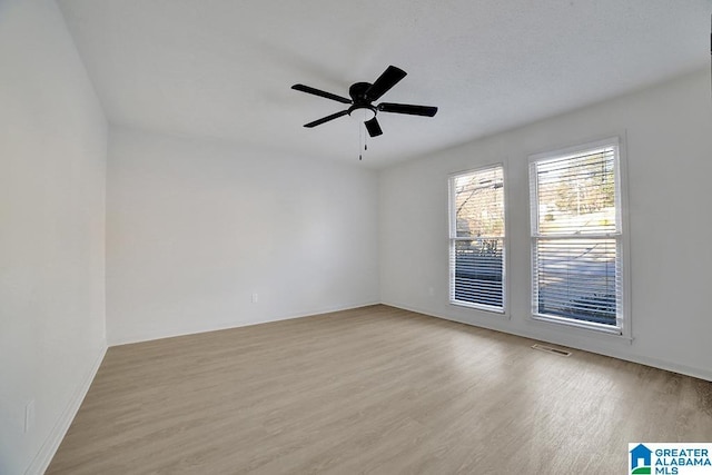 empty room with ceiling fan and light wood-type flooring