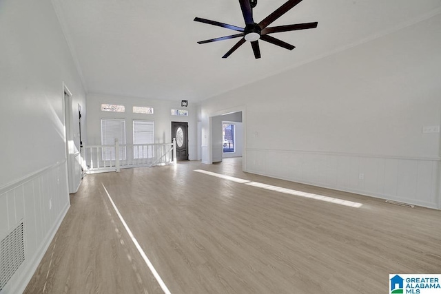 unfurnished living room featuring ceiling fan and light hardwood / wood-style floors