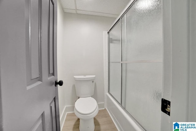 bathroom with enclosed tub / shower combo, wood-type flooring, and toilet