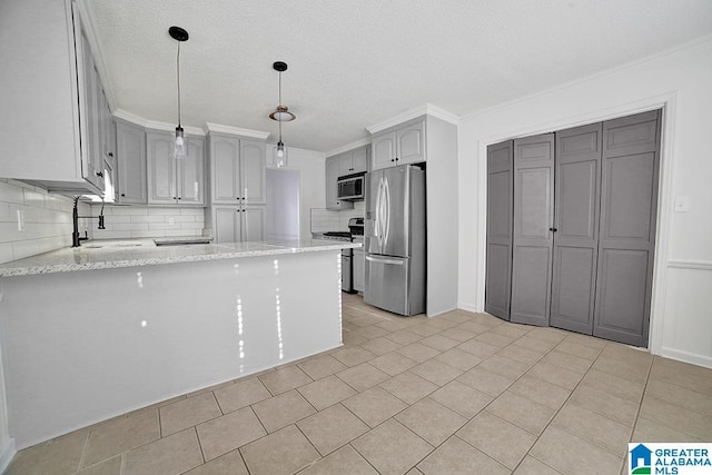 kitchen with sink, appliances with stainless steel finishes, gray cabinetry, decorative light fixtures, and kitchen peninsula