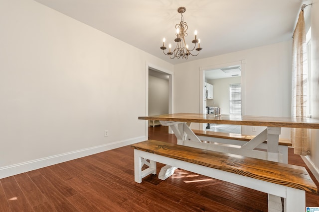 dining area featuring hardwood / wood-style flooring and a notable chandelier