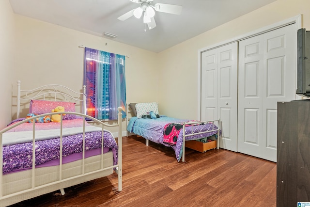 bedroom featuring wood-type flooring, a closet, and ceiling fan