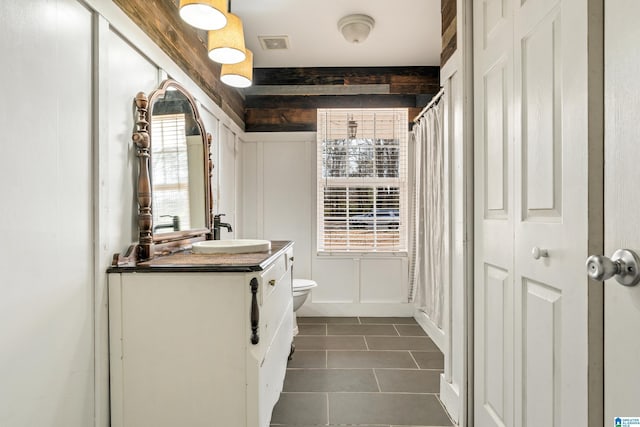 bathroom with vanity, tile patterned flooring, and toilet