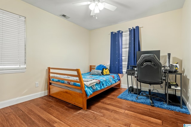 bedroom with wood-type flooring and ceiling fan