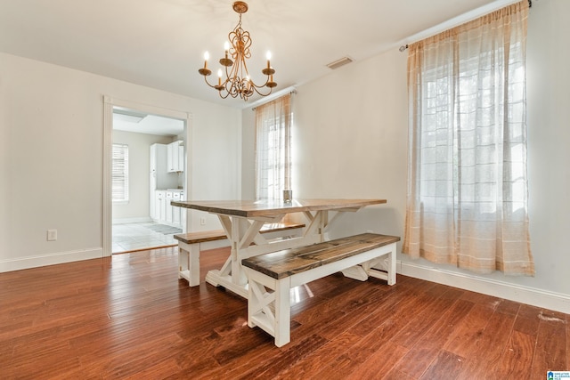 dining area with an inviting chandelier and hardwood / wood-style floors