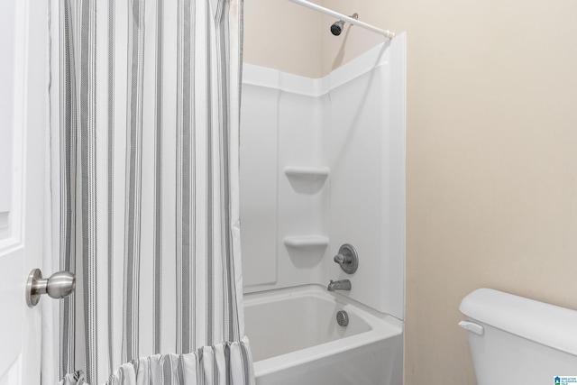 bathroom with shower / bath combo and toilet