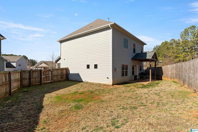 back of house featuring a yard and a patio area