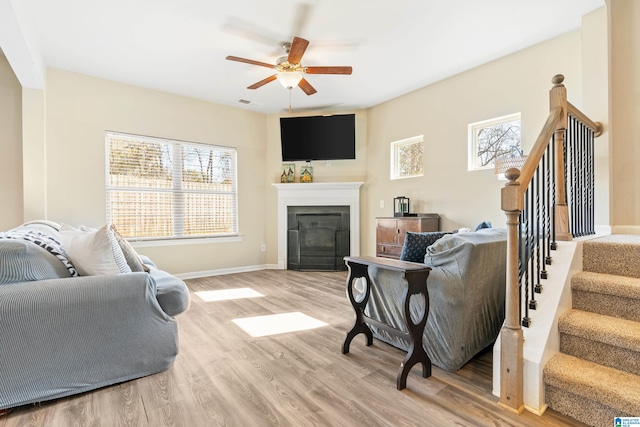 living room with ceiling fan and light hardwood / wood-style floors