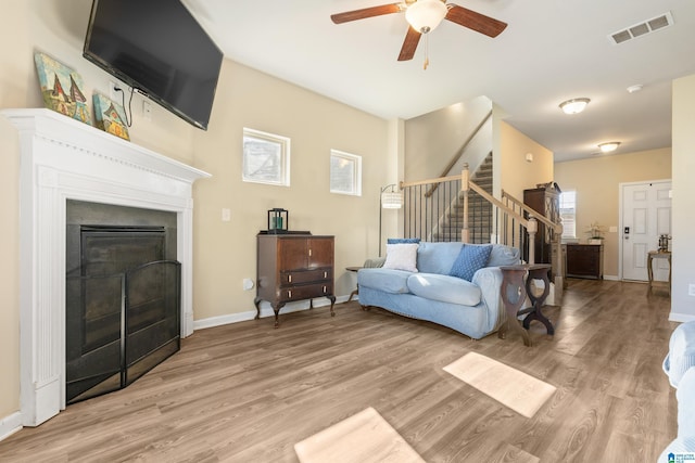 living room featuring ceiling fan and light hardwood / wood-style flooring