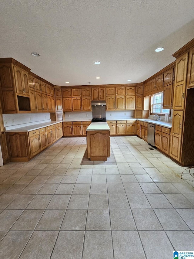 kitchen featuring a kitchen island, sink, stainless steel dishwasher, and light tile patterned floors