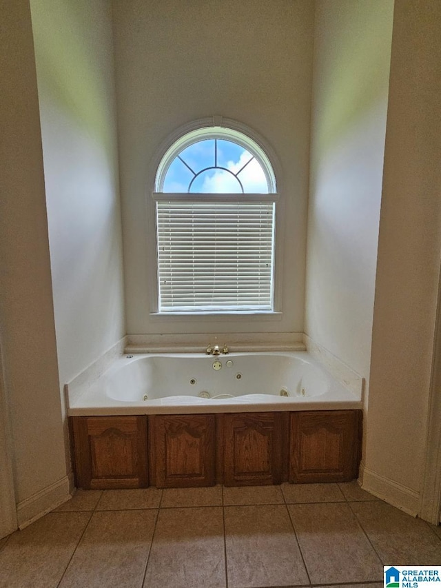 bathroom featuring a bath and tile patterned flooring