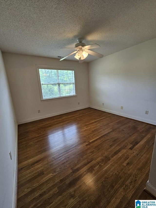 empty room with ceiling fan, a textured ceiling, and dark hardwood / wood-style flooring