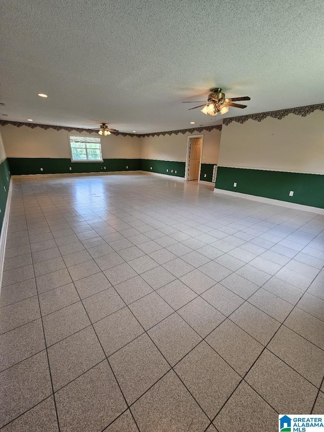 spare room featuring a textured ceiling and ceiling fan