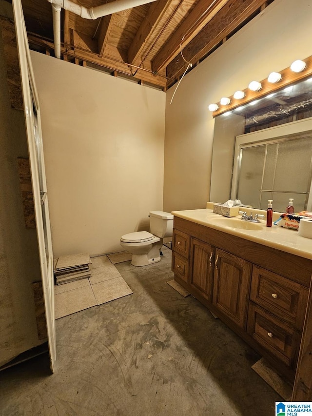 bathroom featuring vanity, toilet, and concrete floors