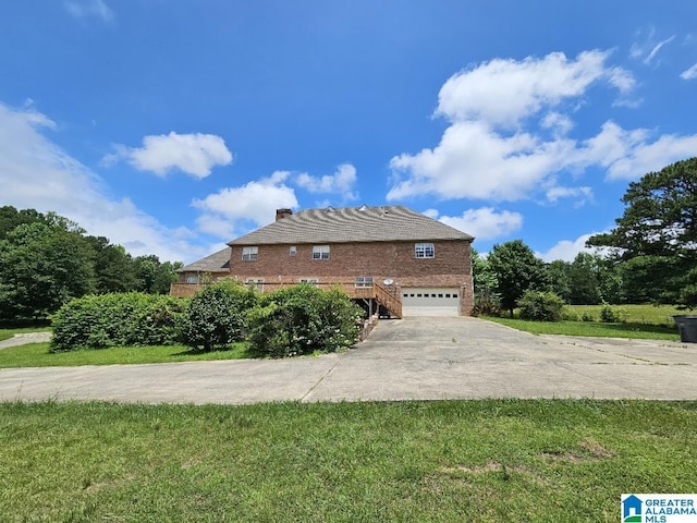 view of home's exterior featuring a garage and a lawn