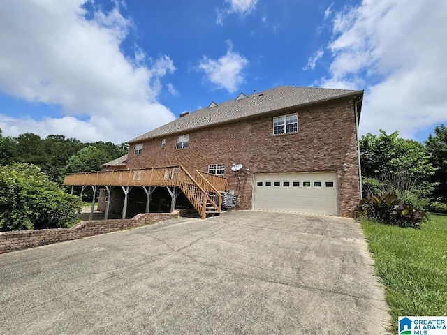 exterior space featuring a garage, central AC, and a deck