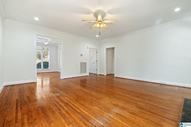 spare room featuring crown molding, wood-type flooring, and ceiling fan