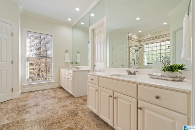 bathroom featuring a shower with door, vanity, and ornamental molding