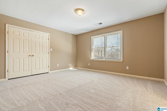 empty room featuring light colored carpet