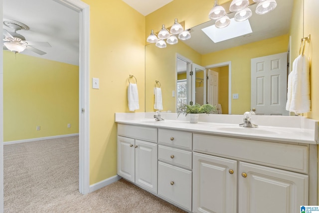 bathroom with vanity, a skylight, and ceiling fan