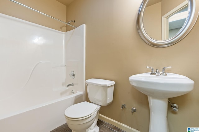 bathroom with tile patterned flooring, shower / bathtub combination, and toilet