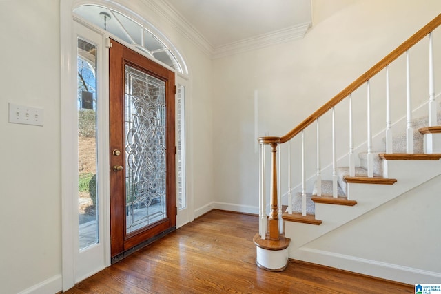 foyer with crown molding and light hardwood / wood-style floors