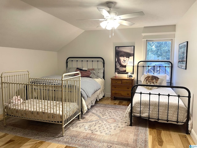 bedroom with wood-type flooring, vaulted ceiling, and ceiling fan