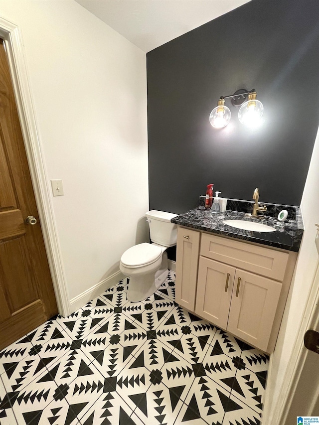 bathroom with tile patterned floors, vanity, and toilet