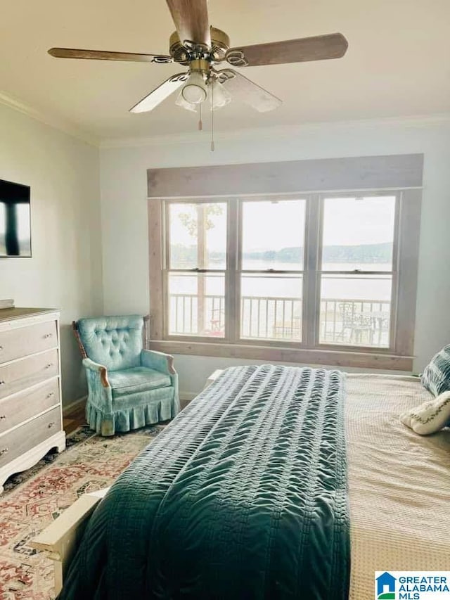 bedroom with ceiling fan and ornamental molding