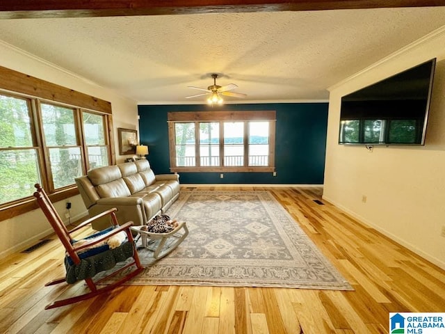 unfurnished living room with hardwood / wood-style flooring, ceiling fan, crown molding, and a textured ceiling