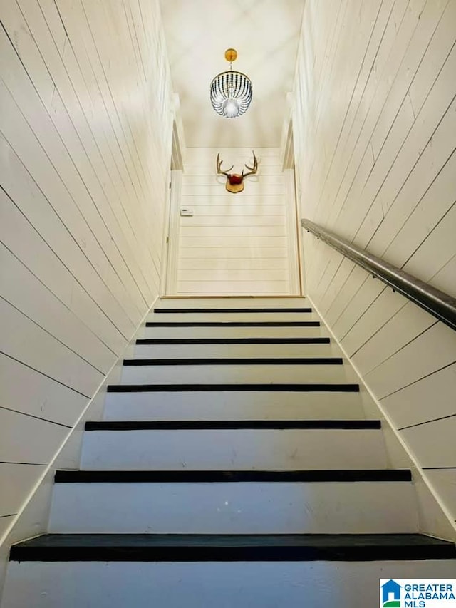 stairs featuring wooden walls