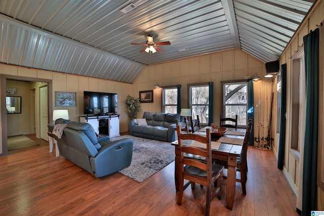 living room featuring hardwood / wood-style flooring, ceiling fan, and lofted ceiling