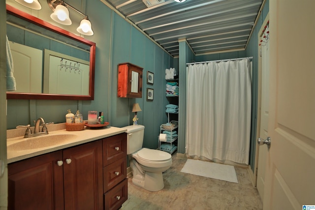 bathroom with walk in shower, vanity, and toilet