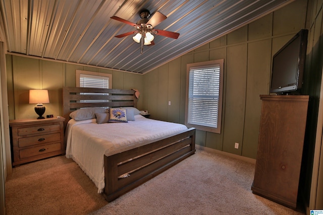 bedroom with ceiling fan, lofted ceiling, and light carpet