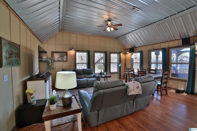 living room featuring ceiling fan, vaulted ceiling, and hardwood / wood-style floors