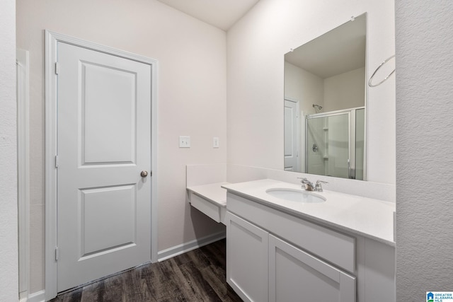 bathroom with vanity, hardwood / wood-style floors, and a shower with shower door