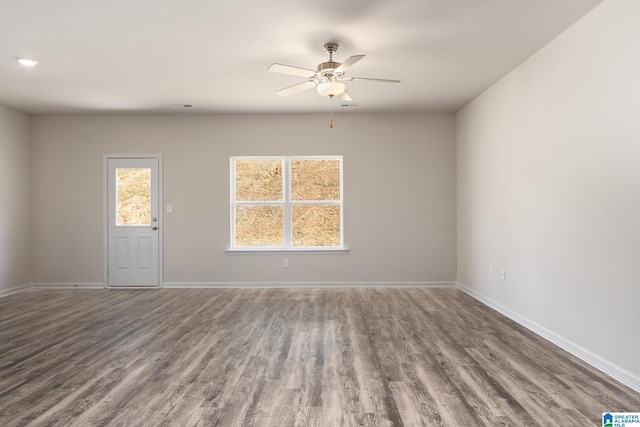 spare room with dark hardwood / wood-style floors and ceiling fan