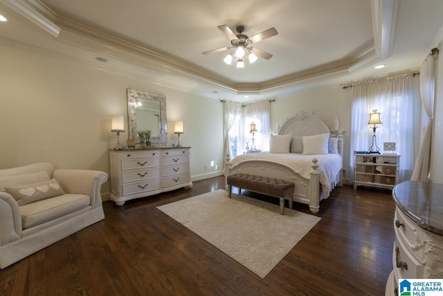 bedroom featuring a tray ceiling, dark hardwood / wood-style floors, and ceiling fan