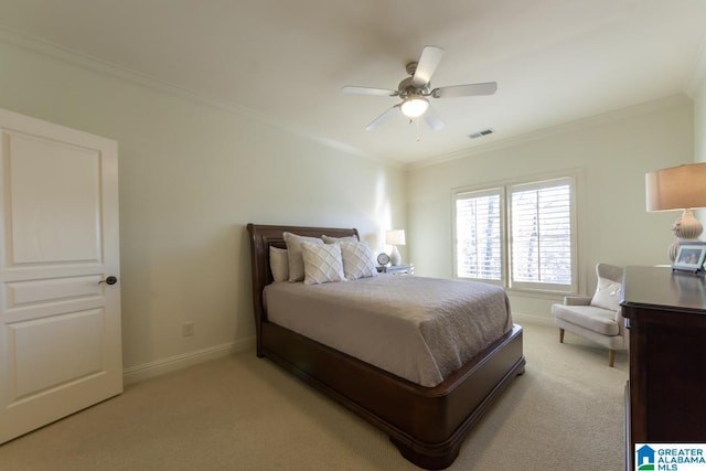 carpeted bedroom with ornamental molding and ceiling fan