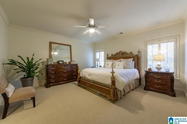 carpeted bedroom featuring ornamental molding and ceiling fan