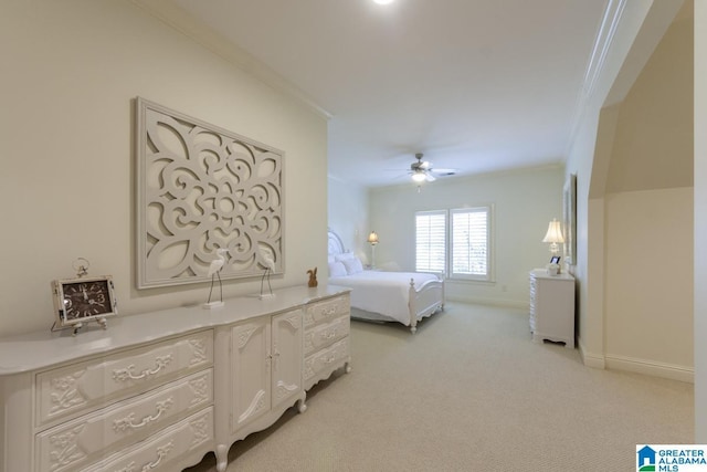 carpeted bedroom with crown molding and ceiling fan