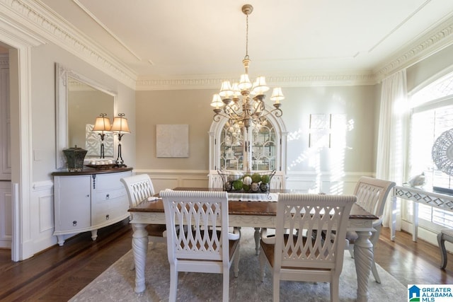 dining room with an inviting chandelier, a wealth of natural light, ornamental molding, and dark hardwood / wood-style floors