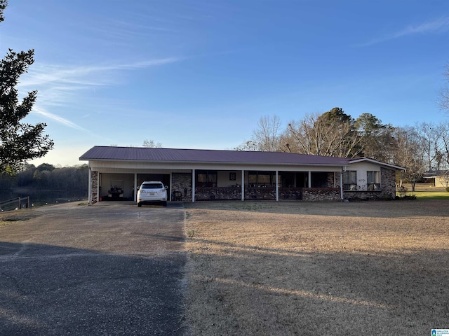 ranch-style house featuring a carport