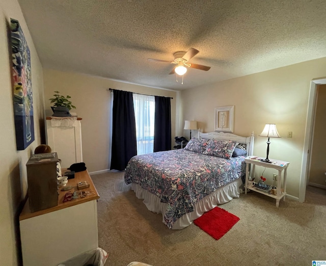 bedroom with carpet, a textured ceiling, and ceiling fan