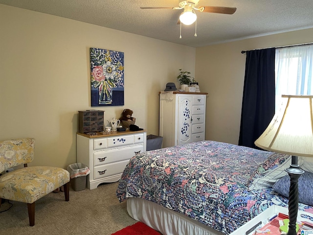 carpeted bedroom with a textured ceiling and ceiling fan