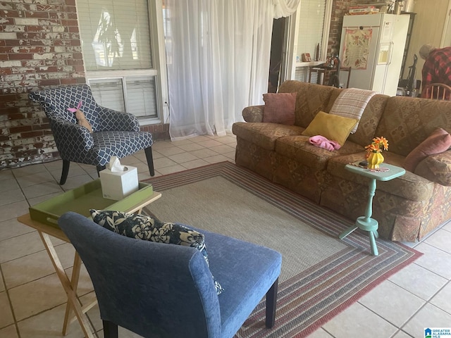 tiled living room featuring brick wall