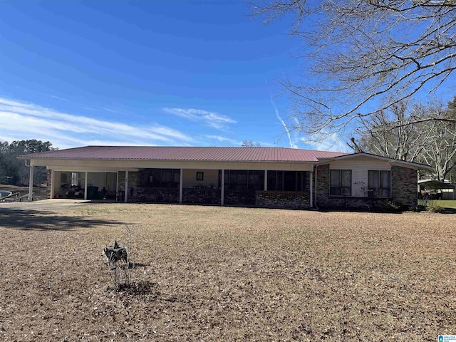 back of property with a carport