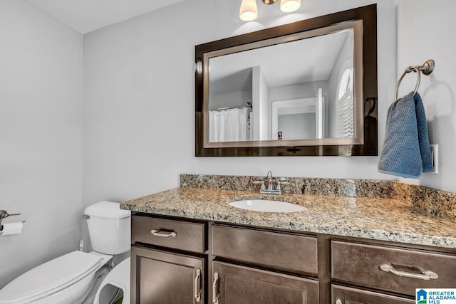 bathroom featuring vanity and toilet