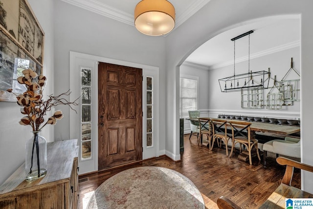 entryway with crown molding and dark hardwood / wood-style floors